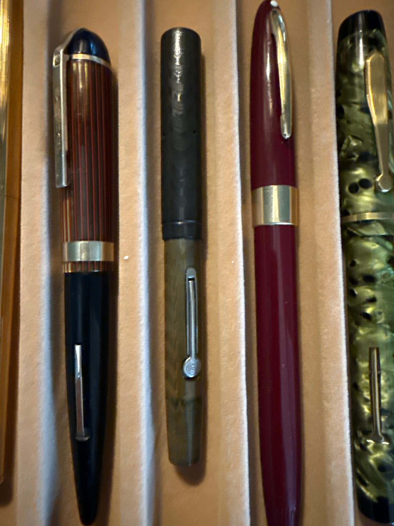 Esterbrook J Series (specifically Dollar Pen or SJ/LJ/J family, shown here is likely an Esterbrook J in green marble on the far right, but focusing on the central prominent ones or collection overall)